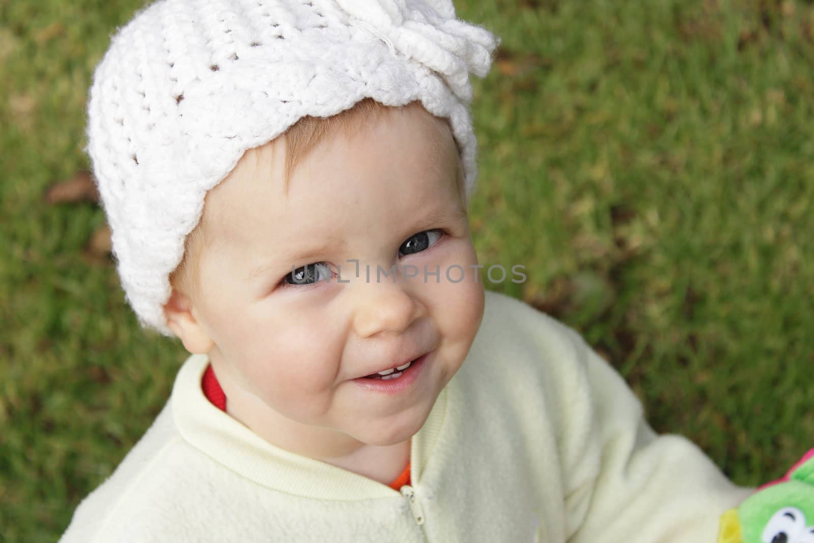 Cute infant girl with knit white hat