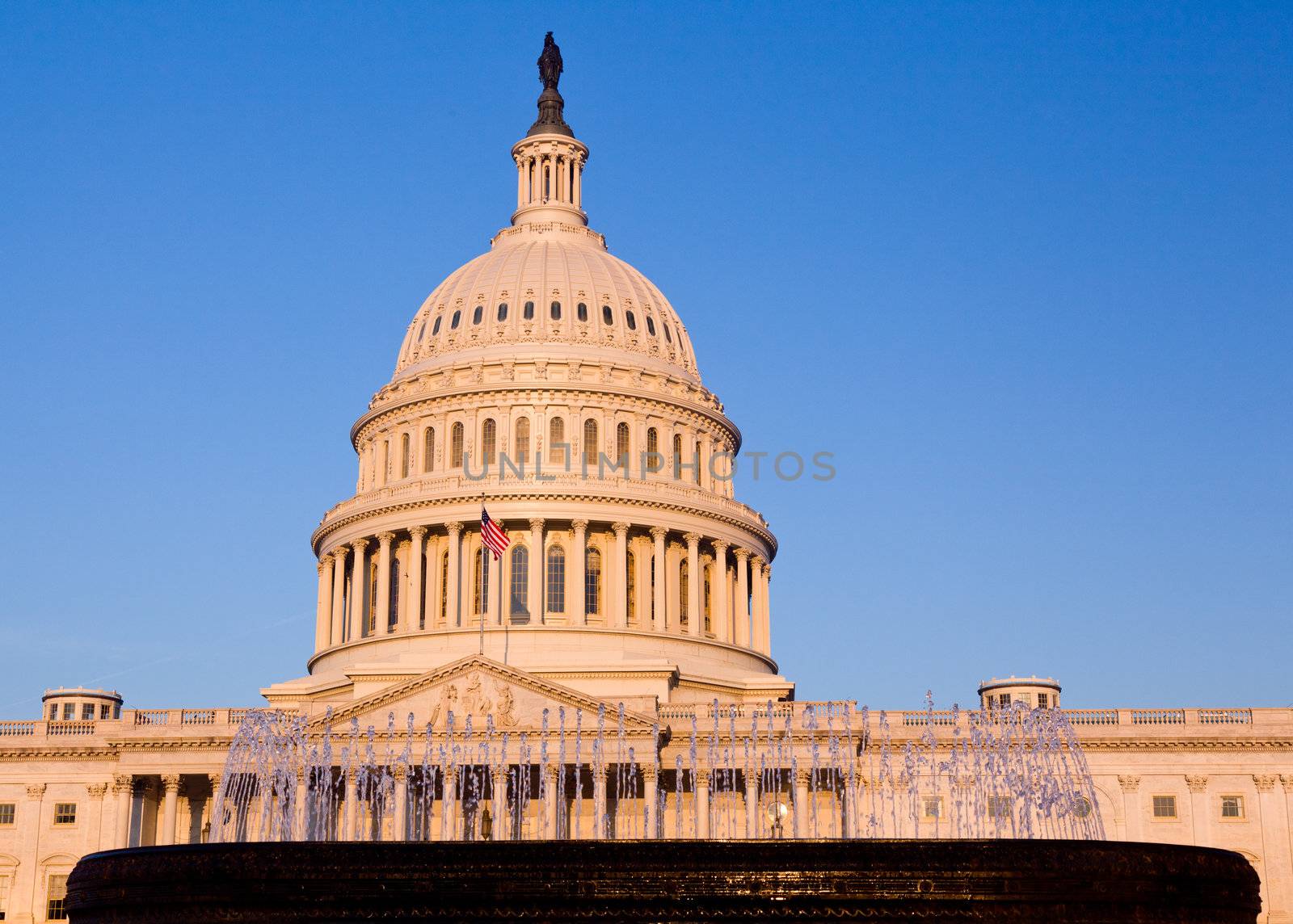 Rising sun illuminates the front of the Capitol building in DC by steheap