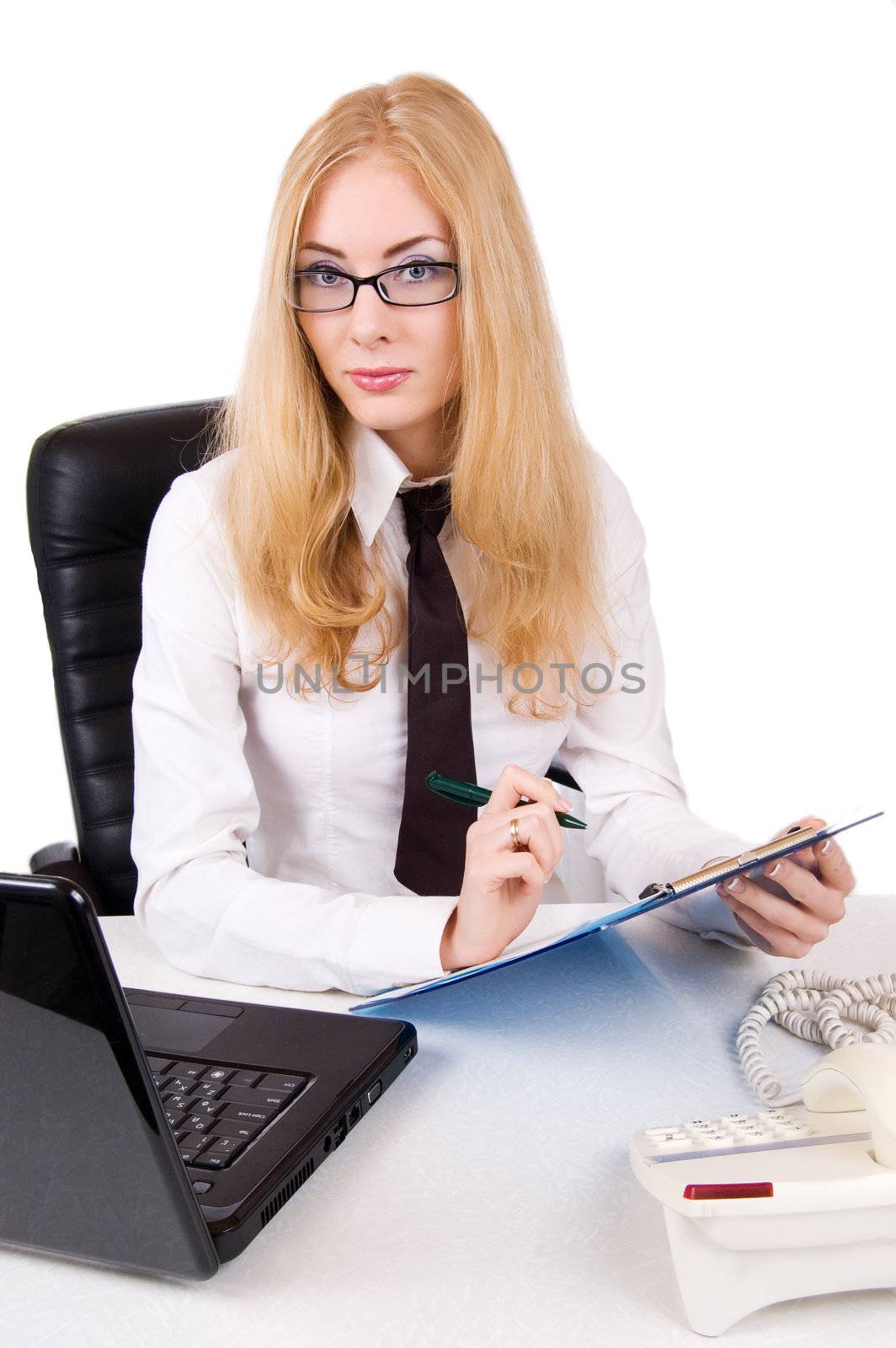 Serious businesswoman in glasses near laptopover white