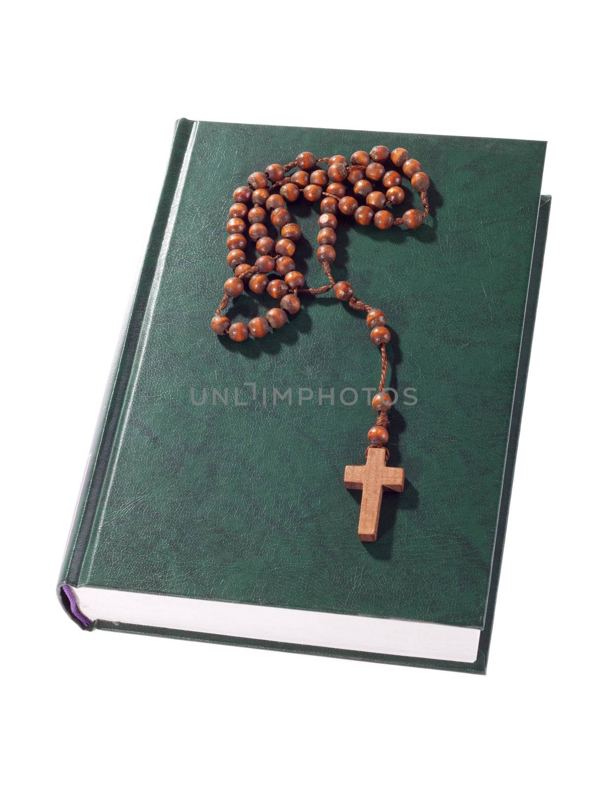 wooden rosary on the Bible, isolated on white