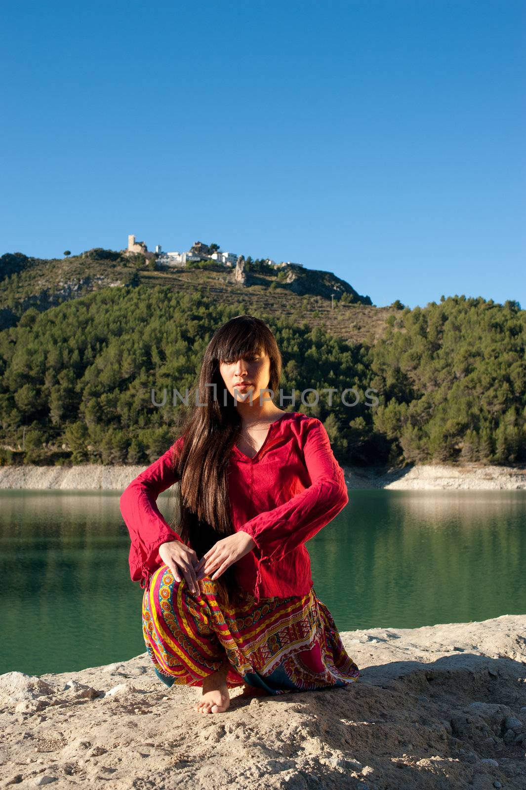 Woman at morning yoga exercises in scenic outdoor setting