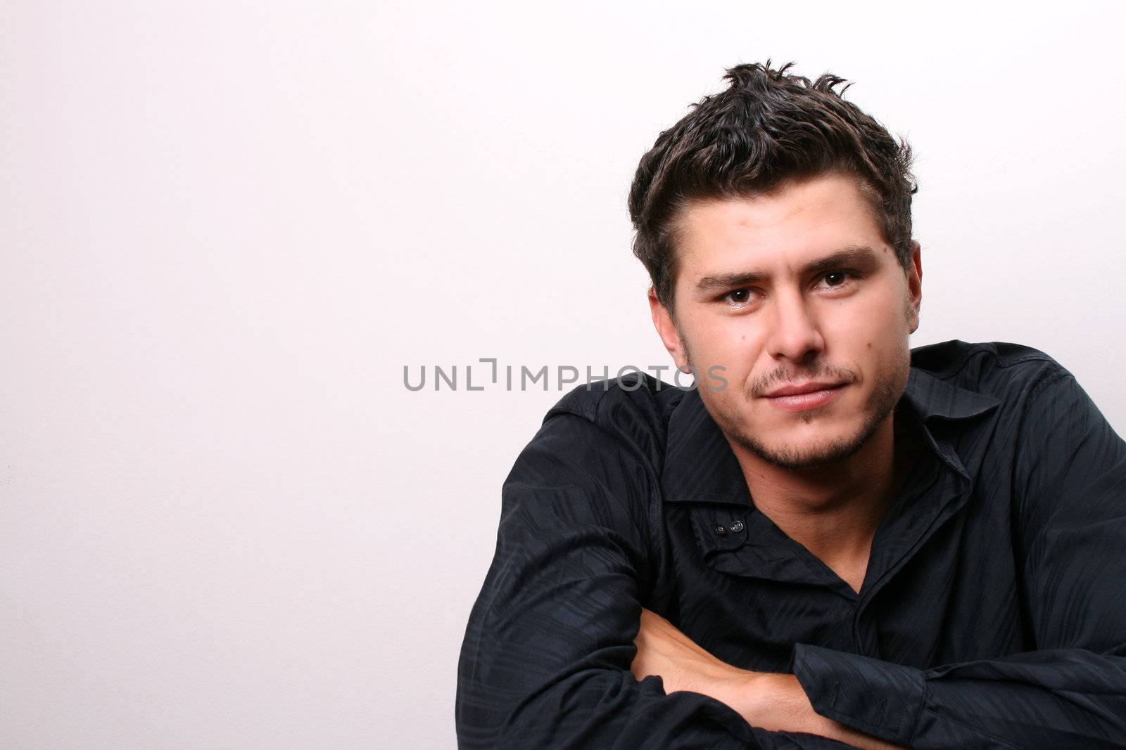 Male model in studio against white wall