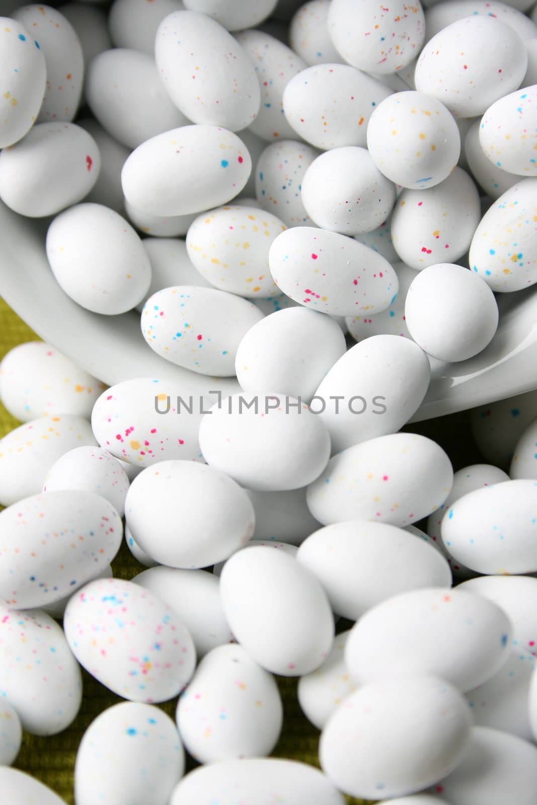 Miniature speckled easter eggs in a green bowl