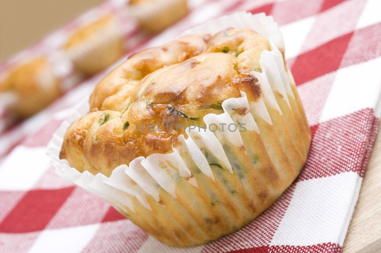 Freshly baked spinach and cheese muffins on a cloth