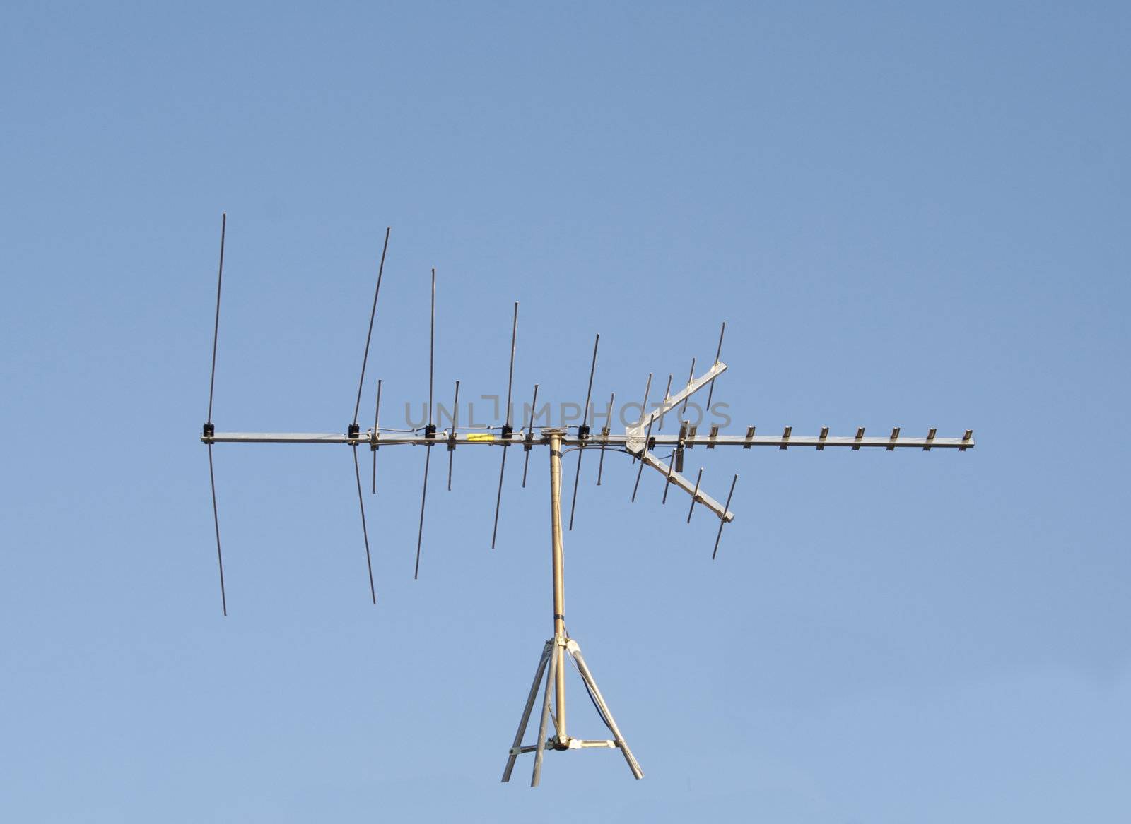Uhf Vhf Television Antenna Isolated against a blue sky to put on whatever you like!