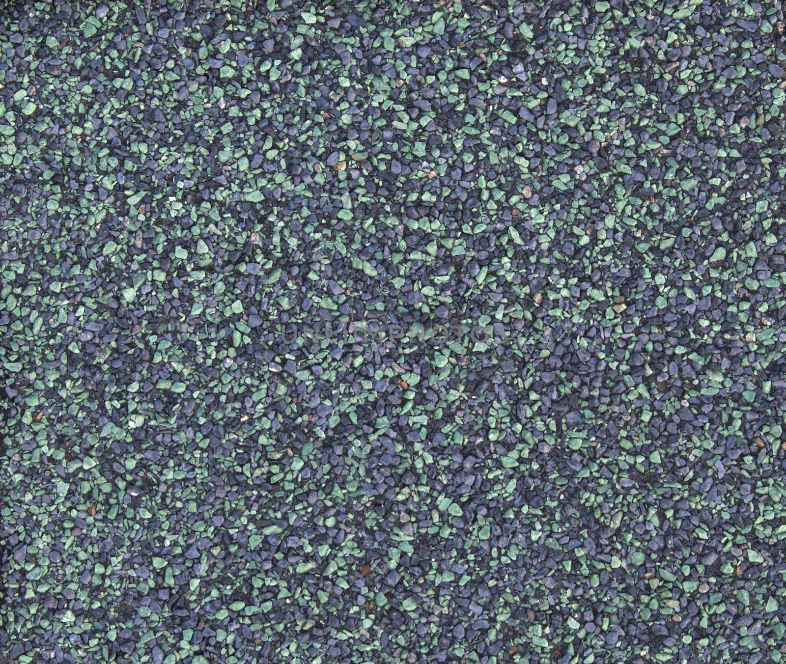 A macro of the stones of a green asphalt shingle