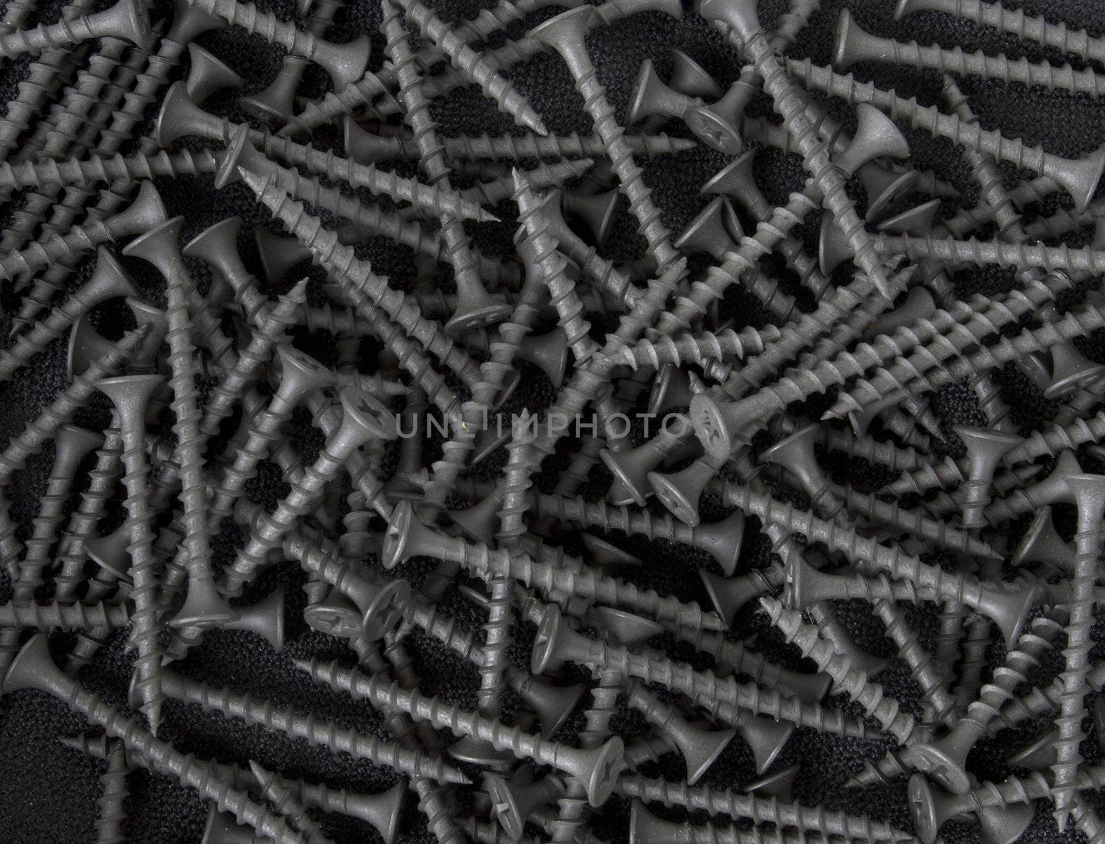 A background or texture of black drywall screws