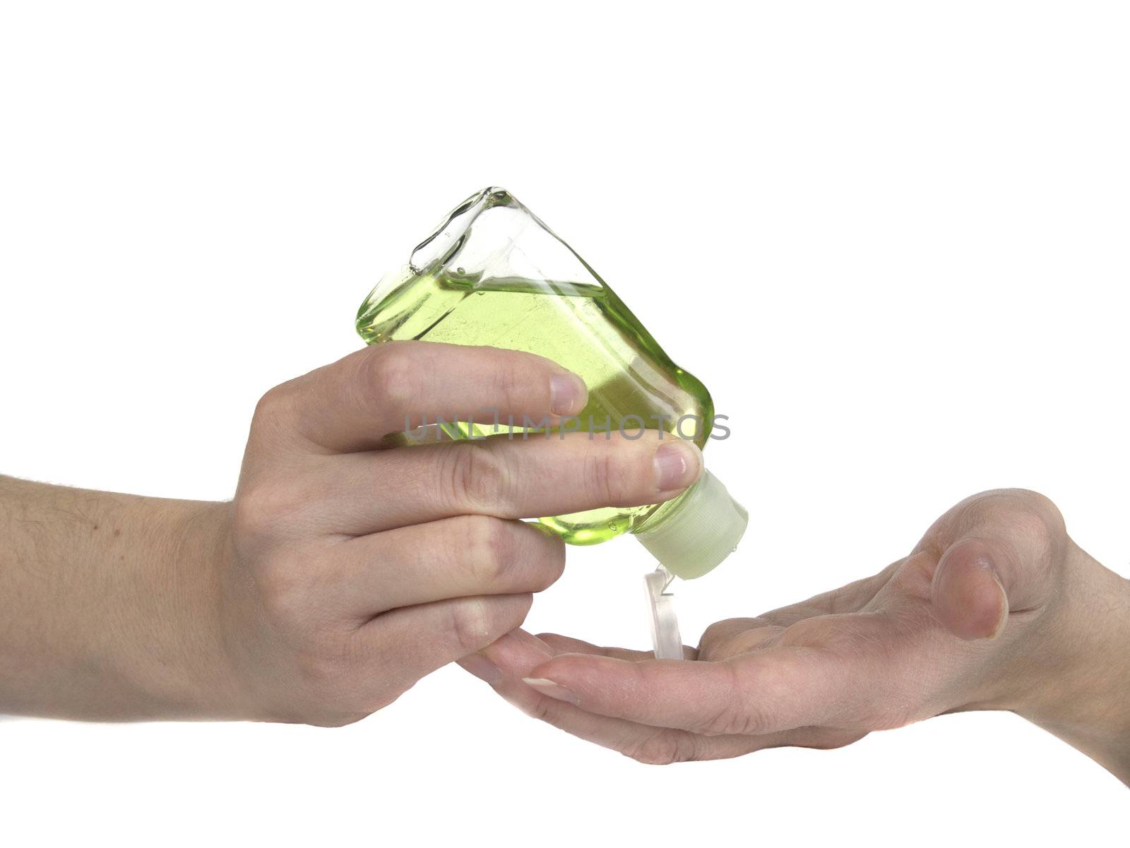Woman squeezing green hand sanitizer lotion onto her hands.
