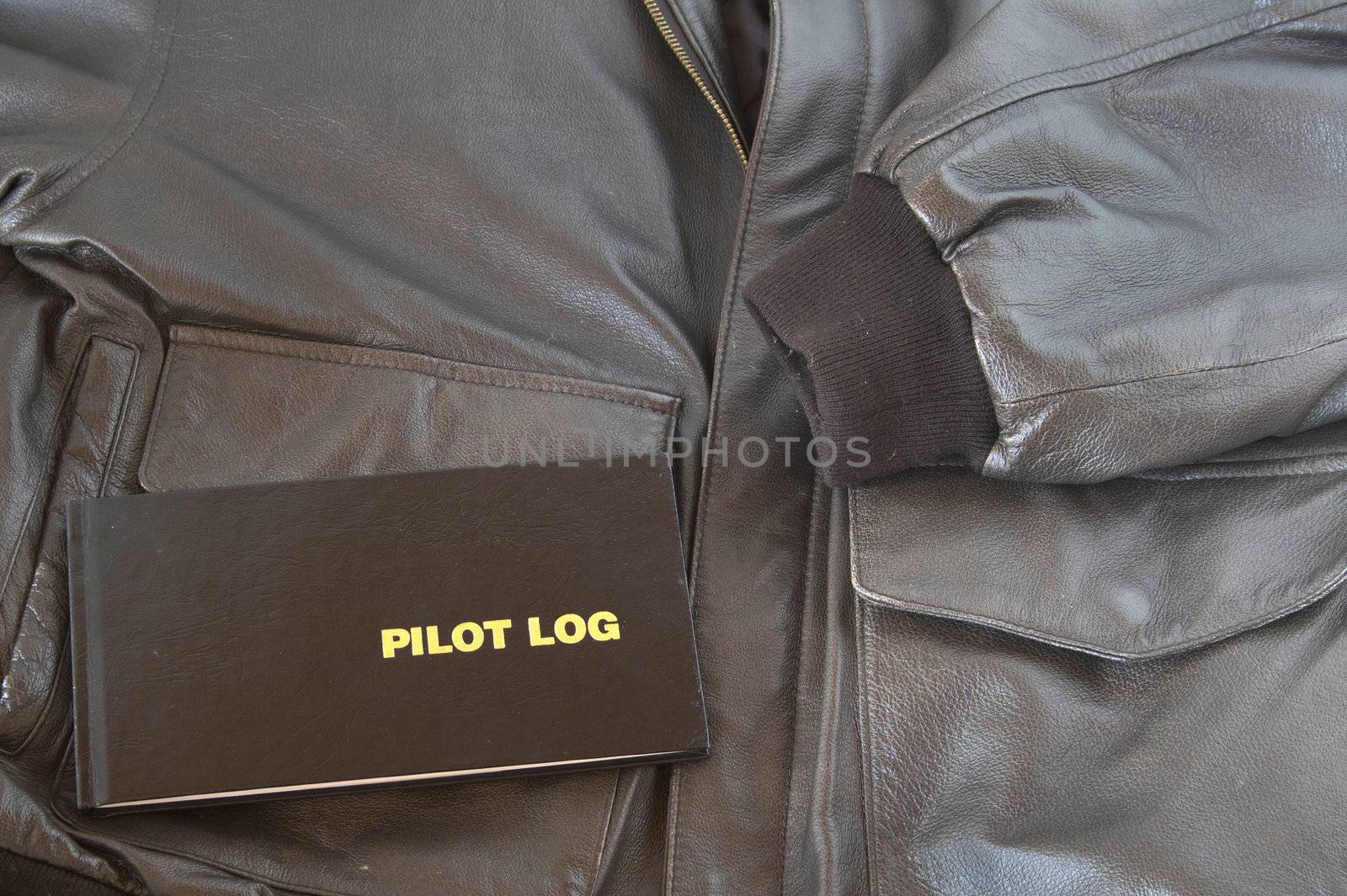 A Pilots log sits on top of a leather A4 aviator jacket