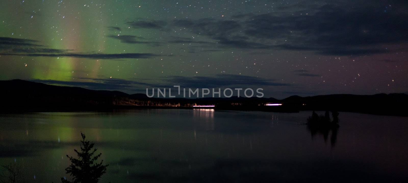 Stars and Northern Lights over dark Road at Lake by PiLens