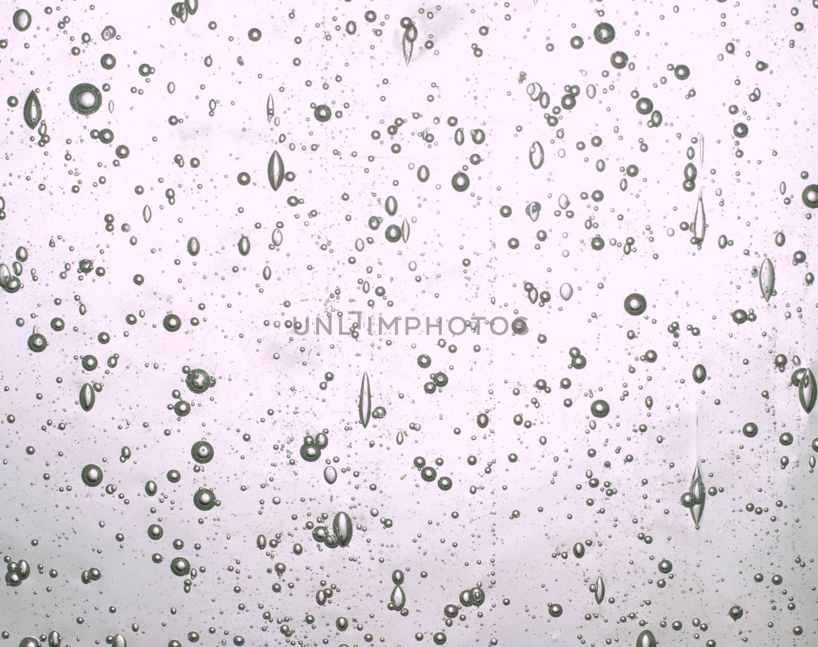 Abstract background of bubbles suspended in clear glass