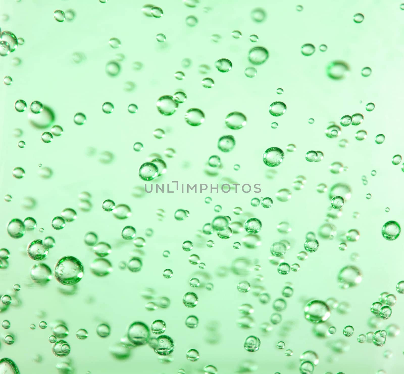 Bubbles suspended in a very vibrant green gel
