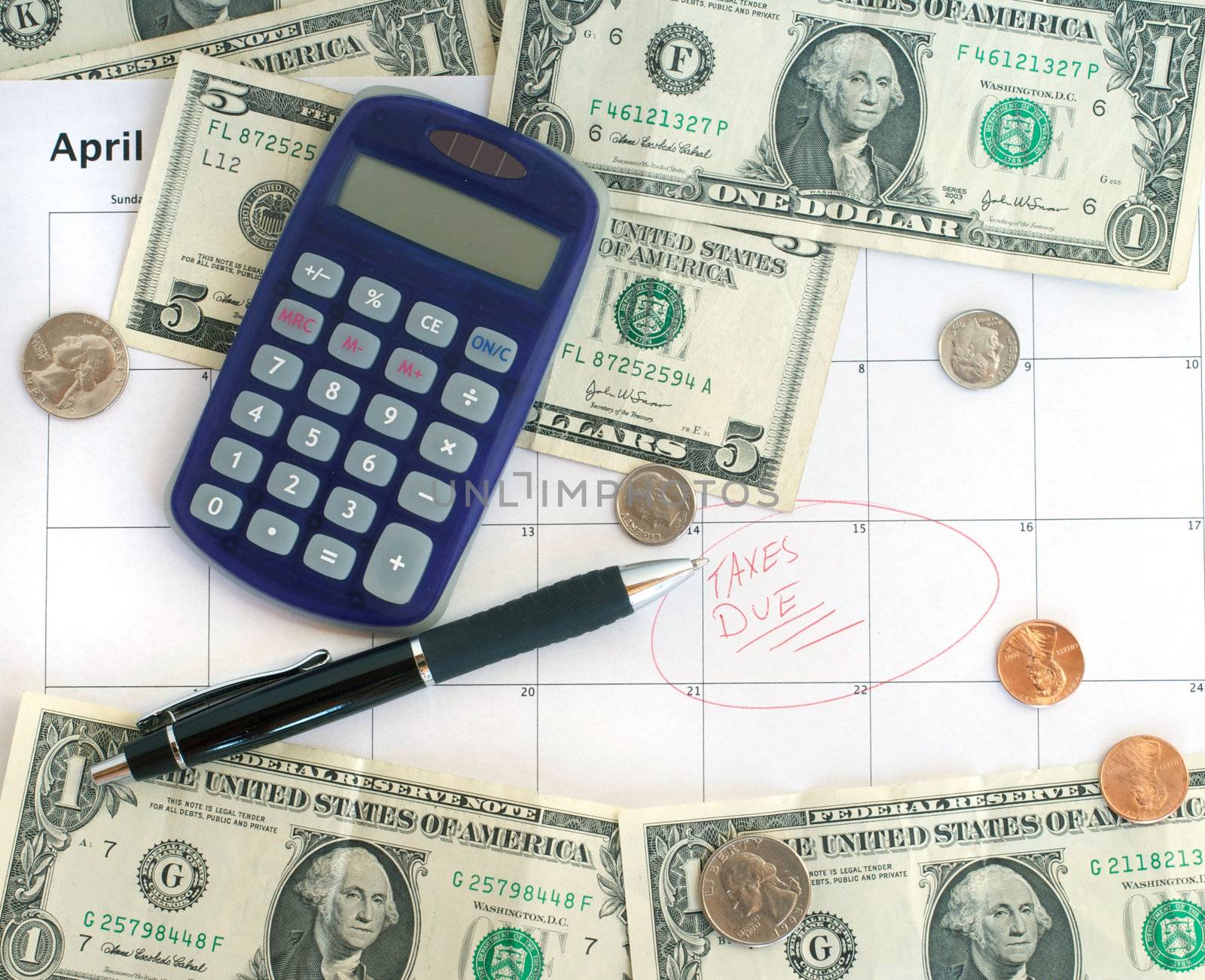 Calendar showing the taxes due date with some money and a calculator.