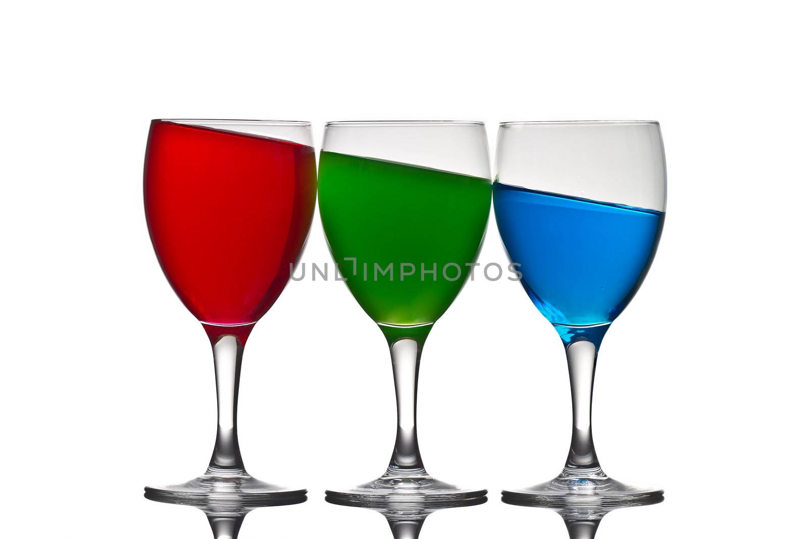 Three wine glasses with  colored liquid depicting the RGB color system