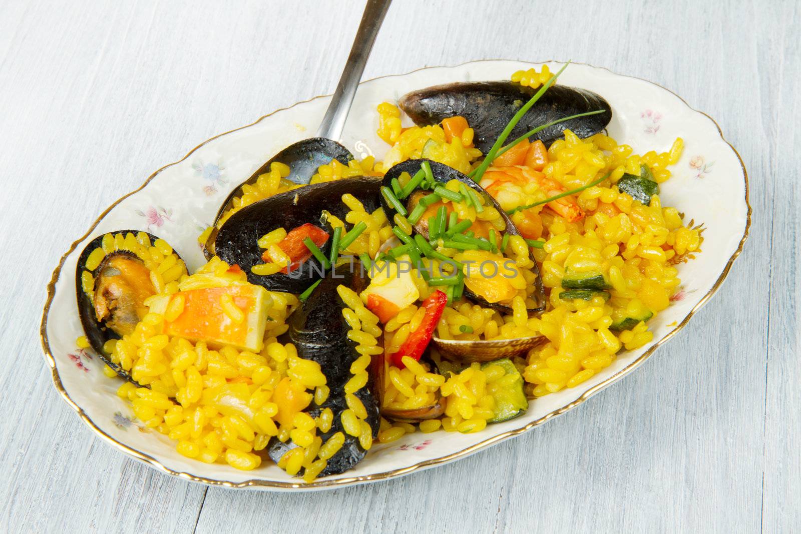 Close-up of Spanish paella on white plate