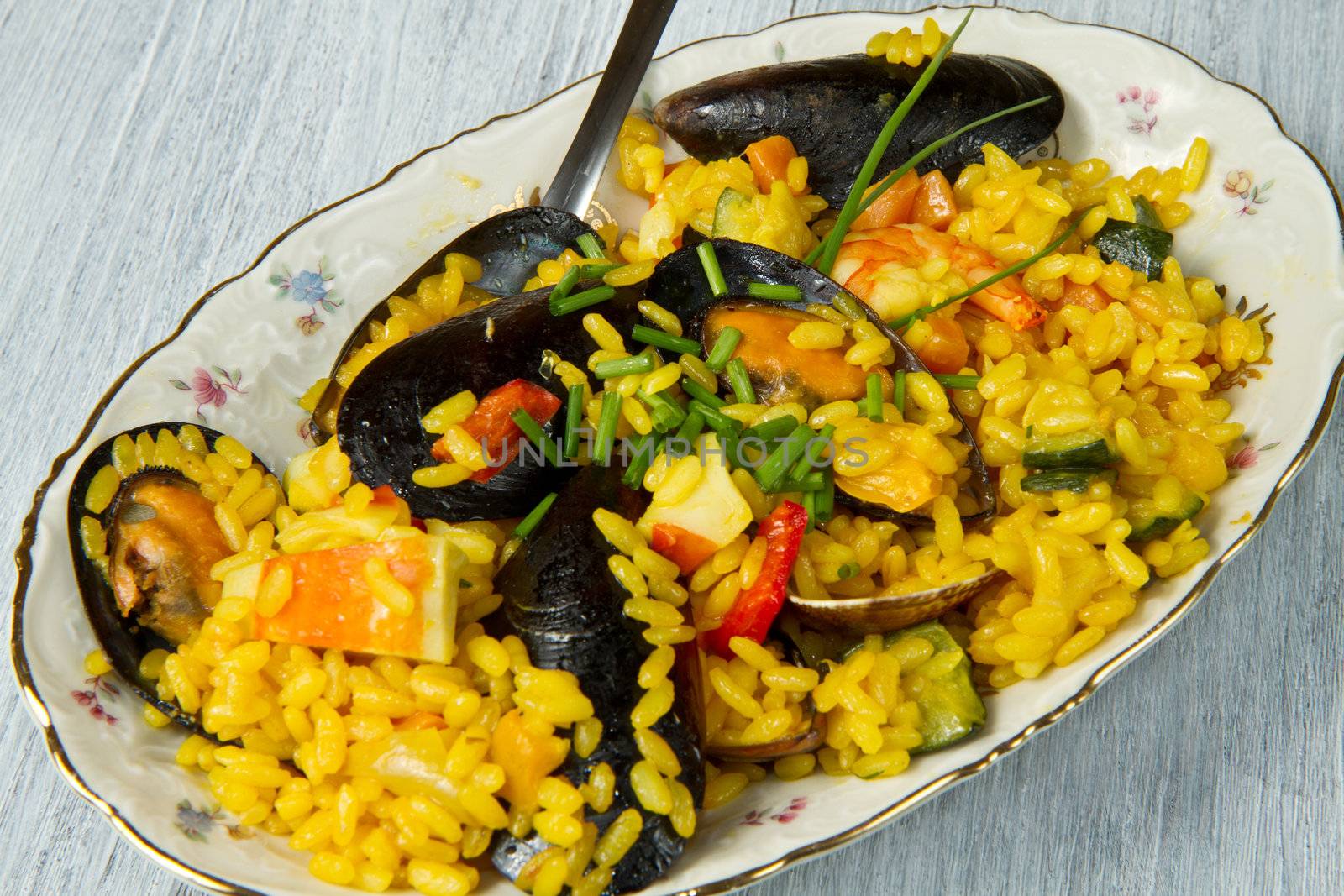 Close-up of Spanish paella on white plate