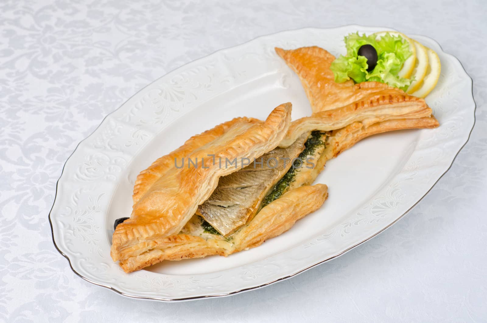 tasty dish of trout fish baked with greens at dough