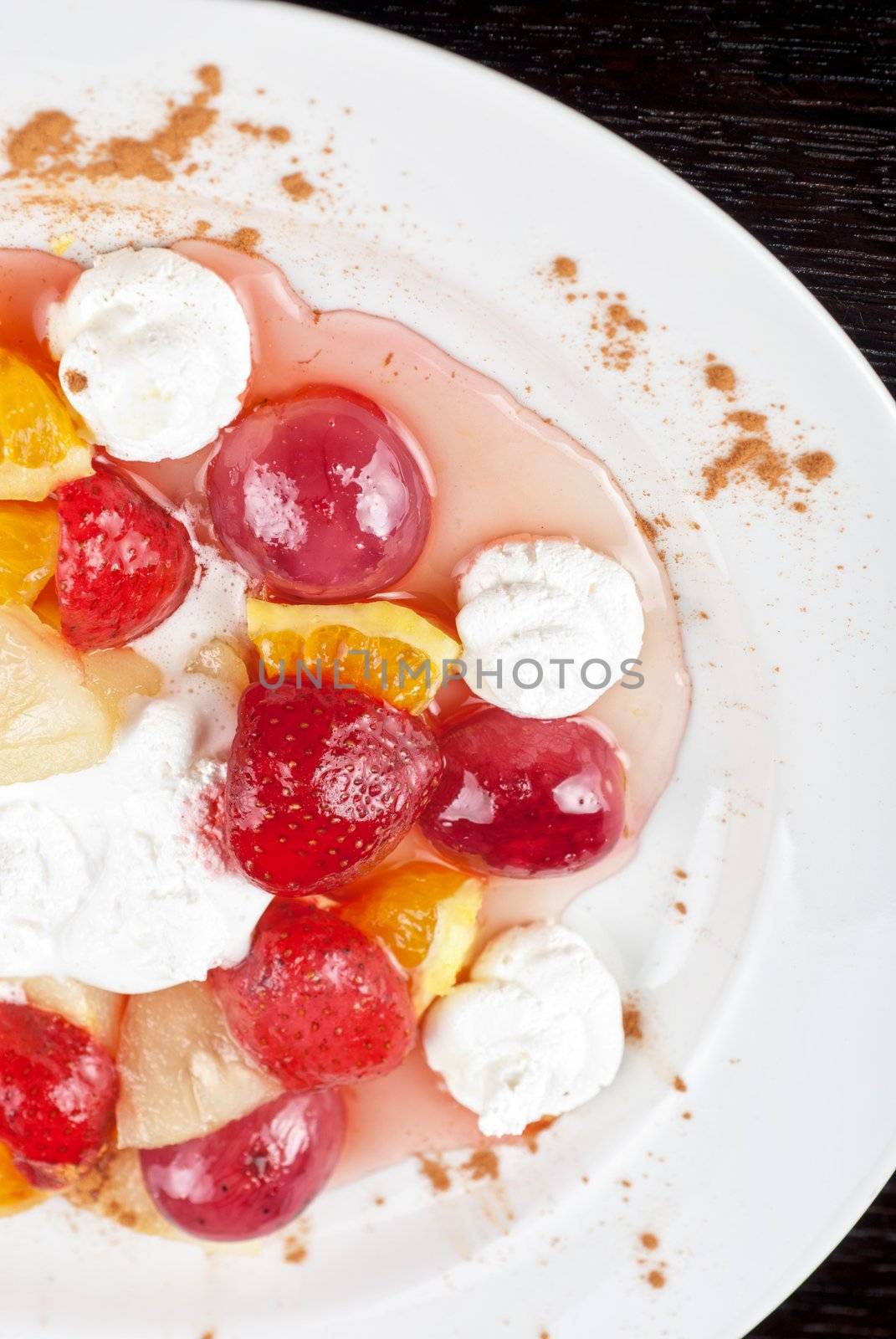 fruit salad of pineapple, grape, orange and strawberry with whipped cream