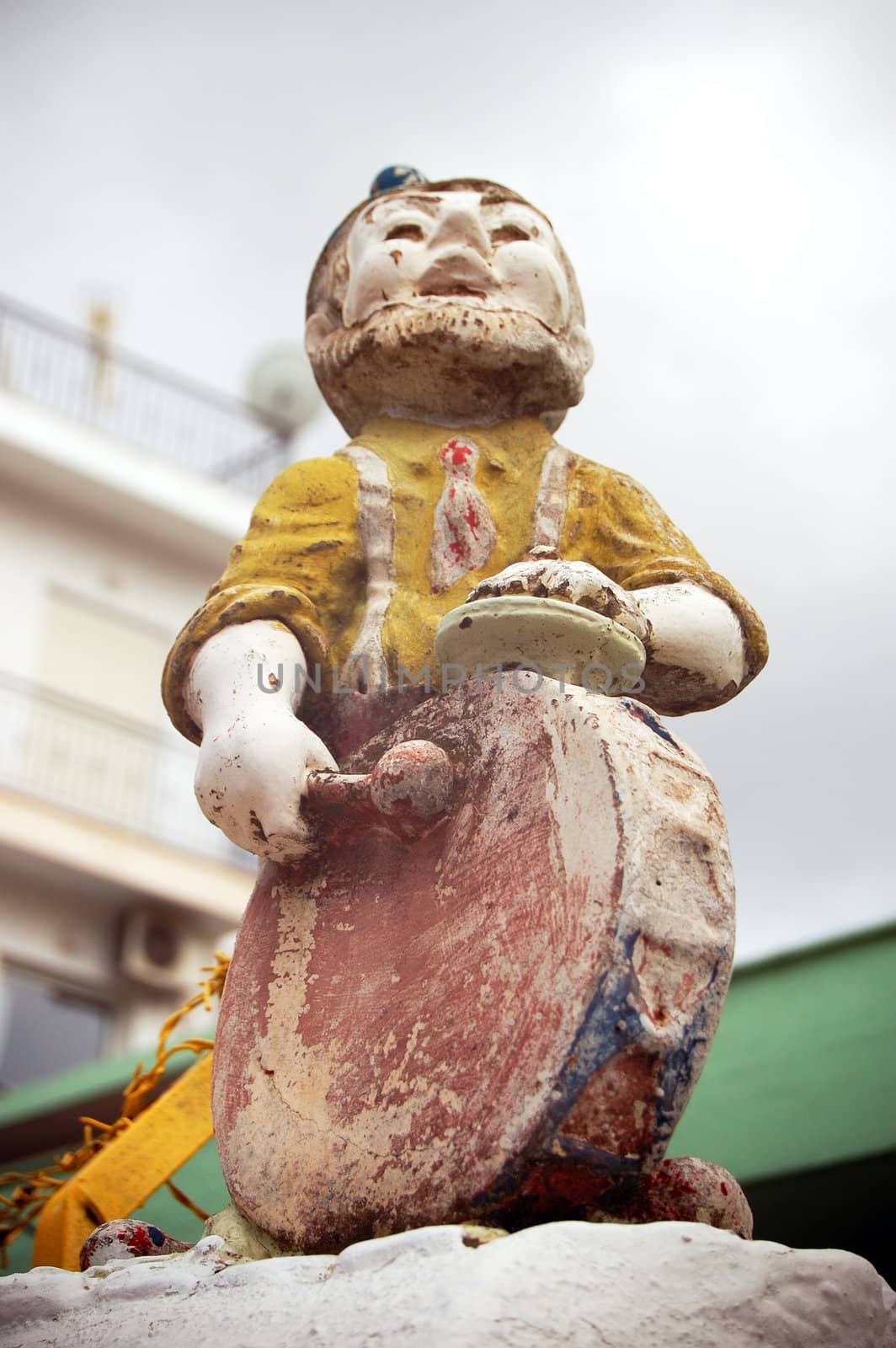 Vintage weathered decorative garden gnome with drum.