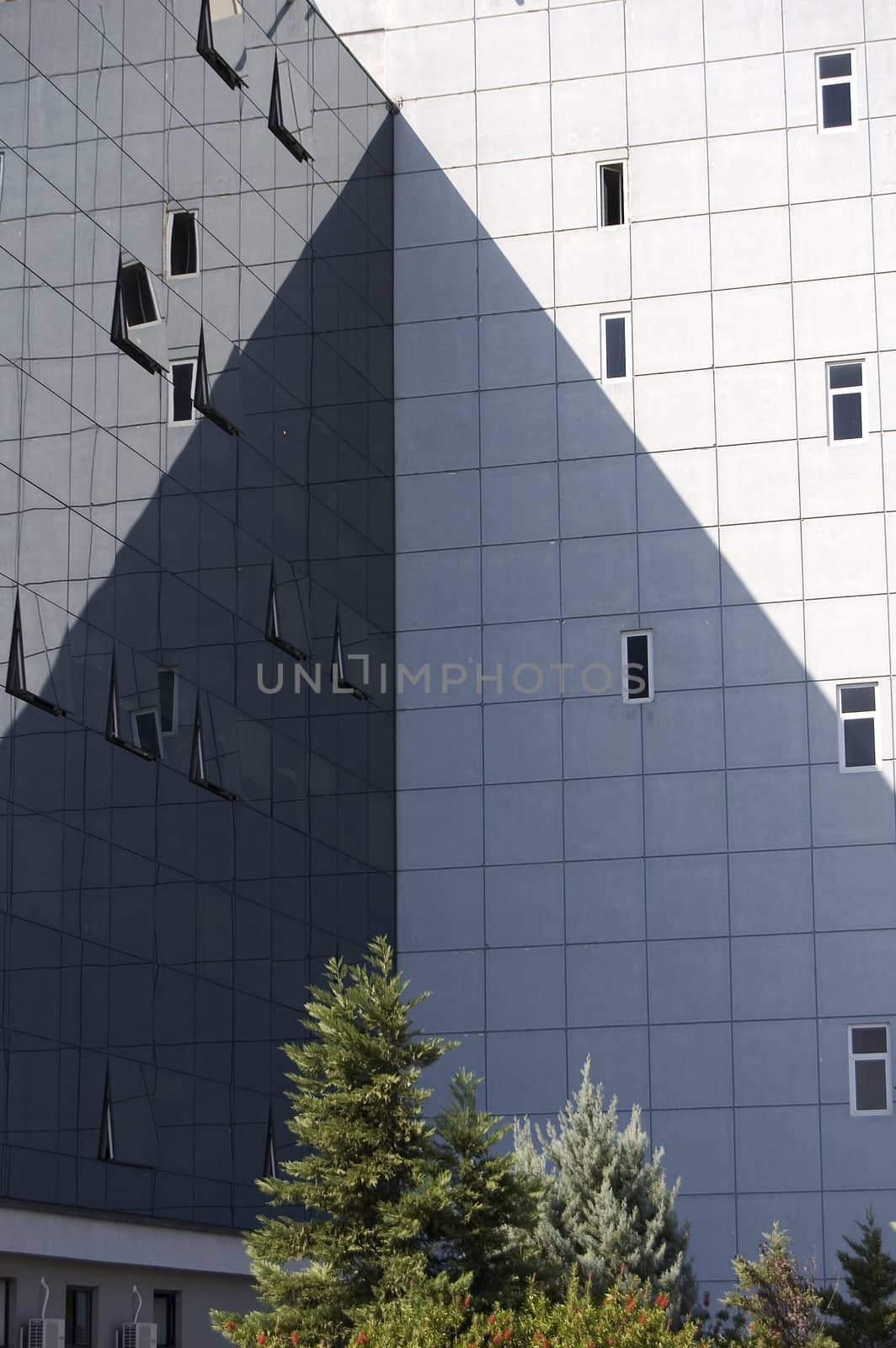 Modern architecture. Glass office buildings cast shadow.