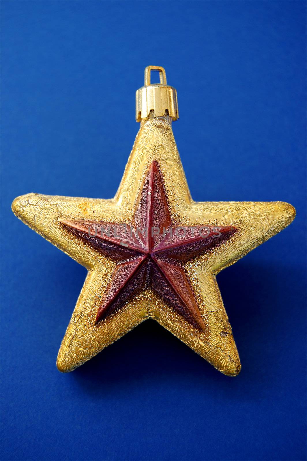 Christmas tree decoration. Golden star ornament background.