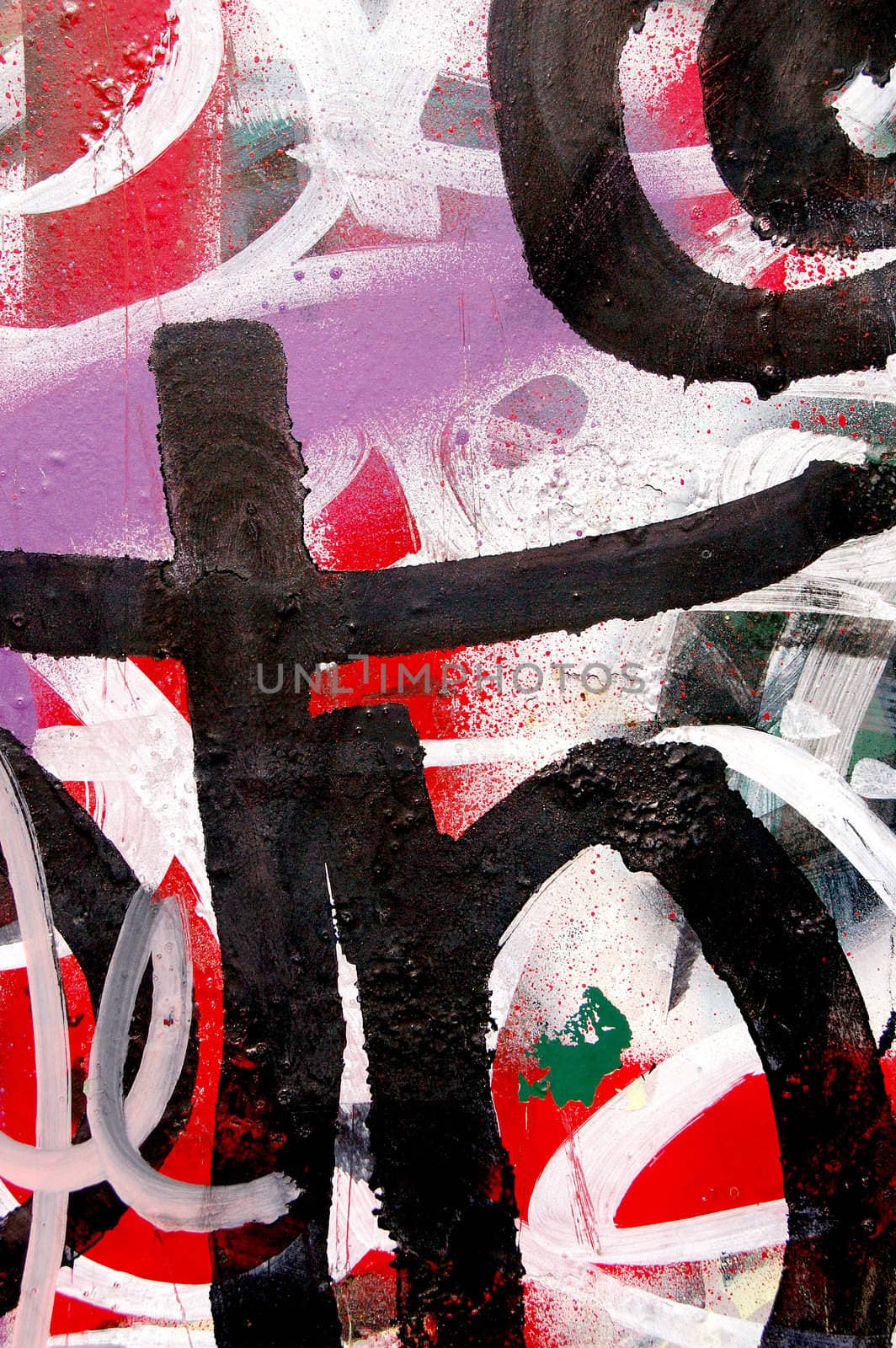 A surface covered with layers of graffiti and tags.