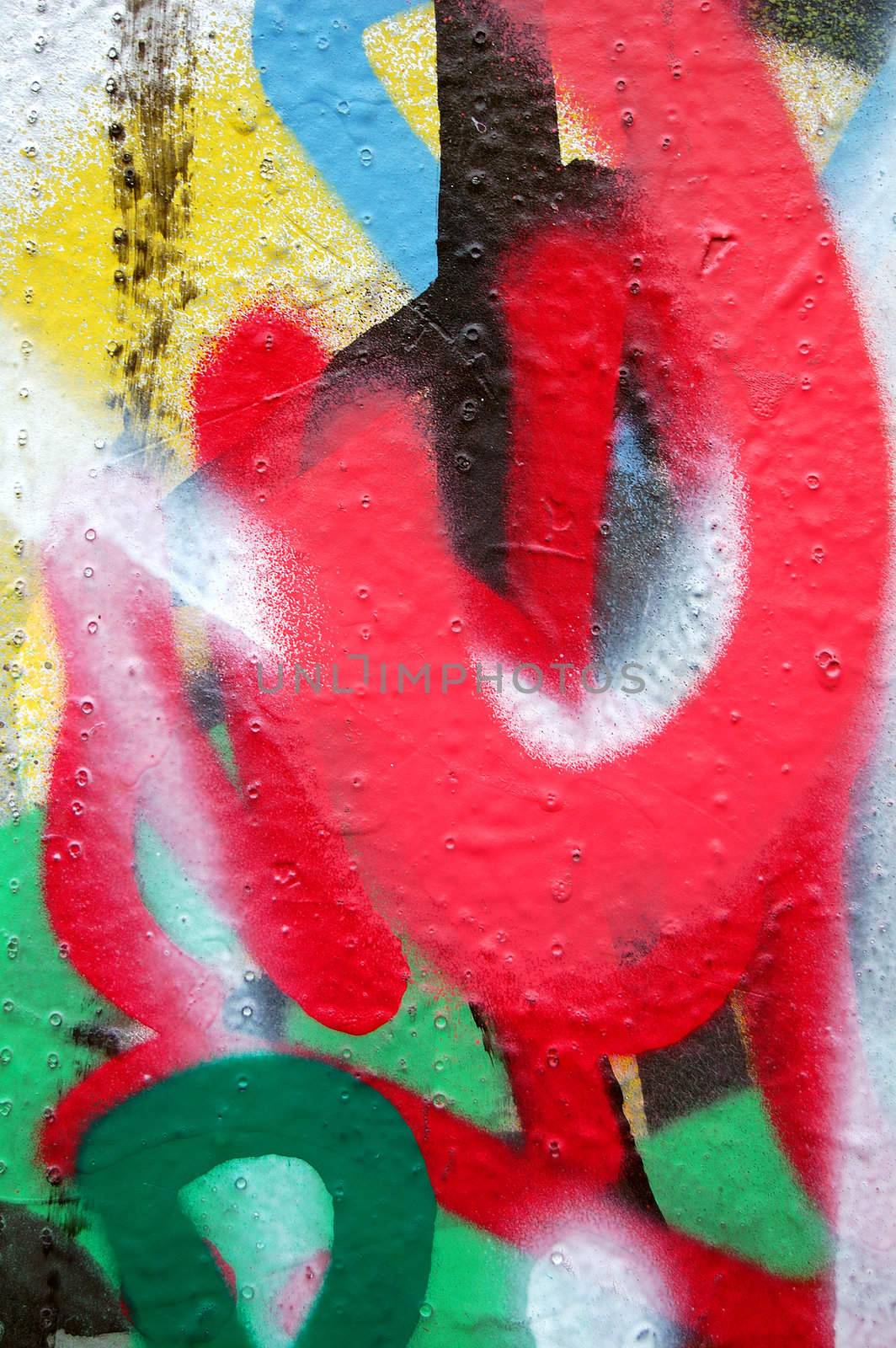 Detail of a wall covered with layers of graffiti.