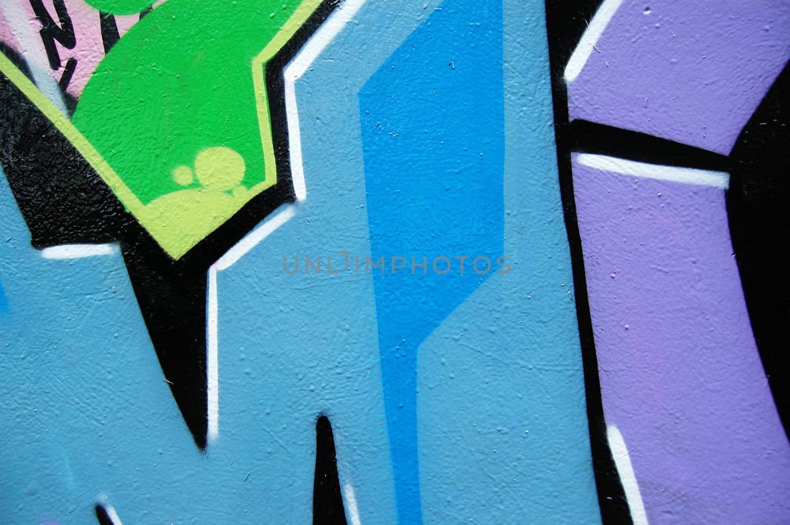 Detail of wall surface covered with graffiti and tags.