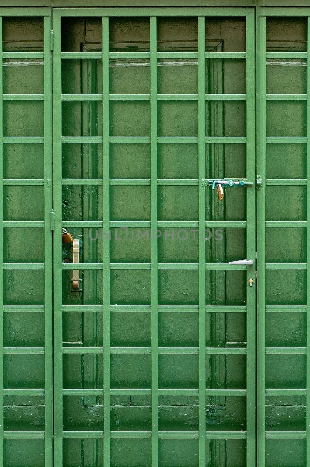 Wooden green door and protective metal frame.