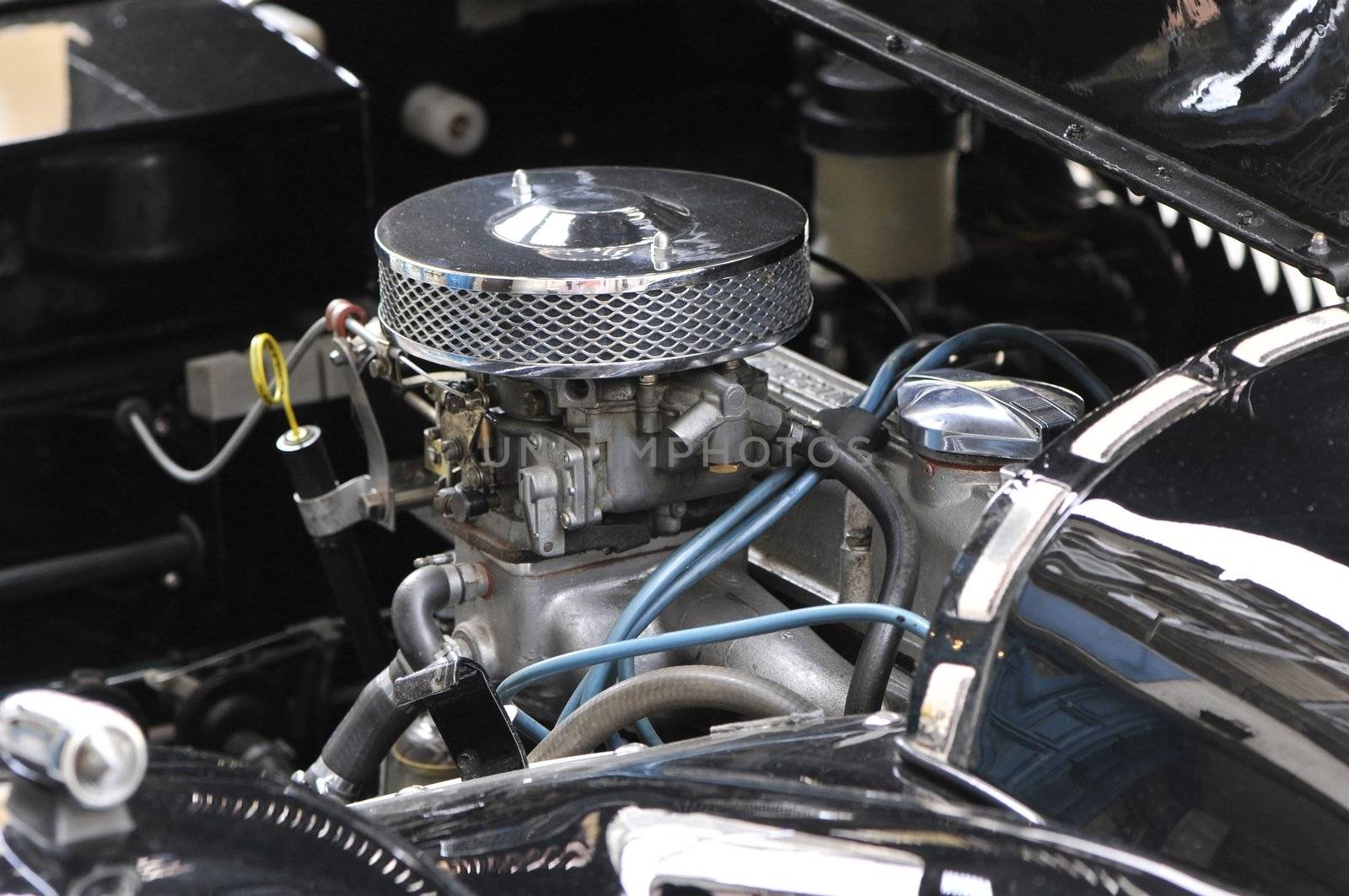 Chromed motor of an old black Morgan car