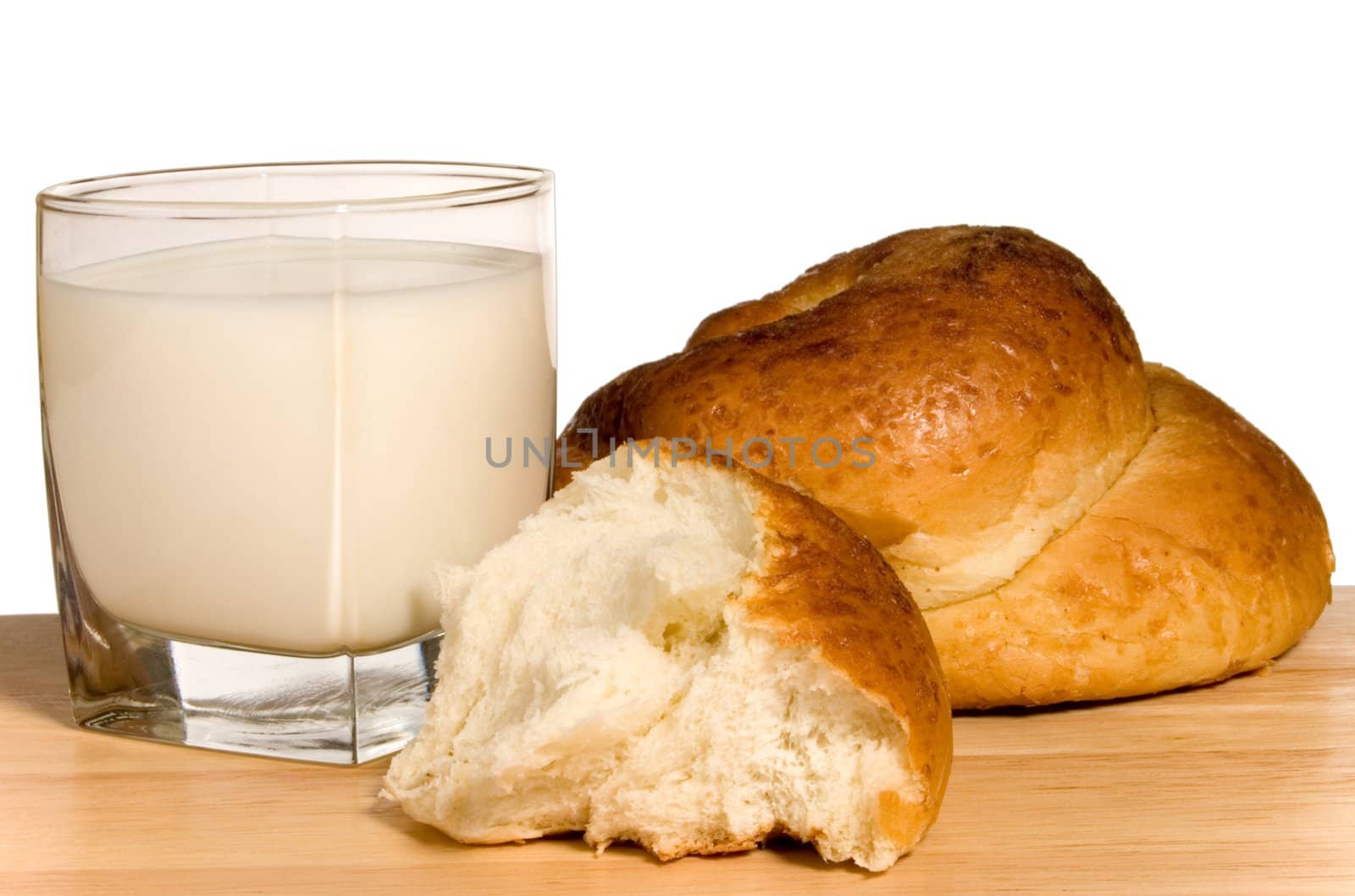 Glass of milk and white pastry isolated