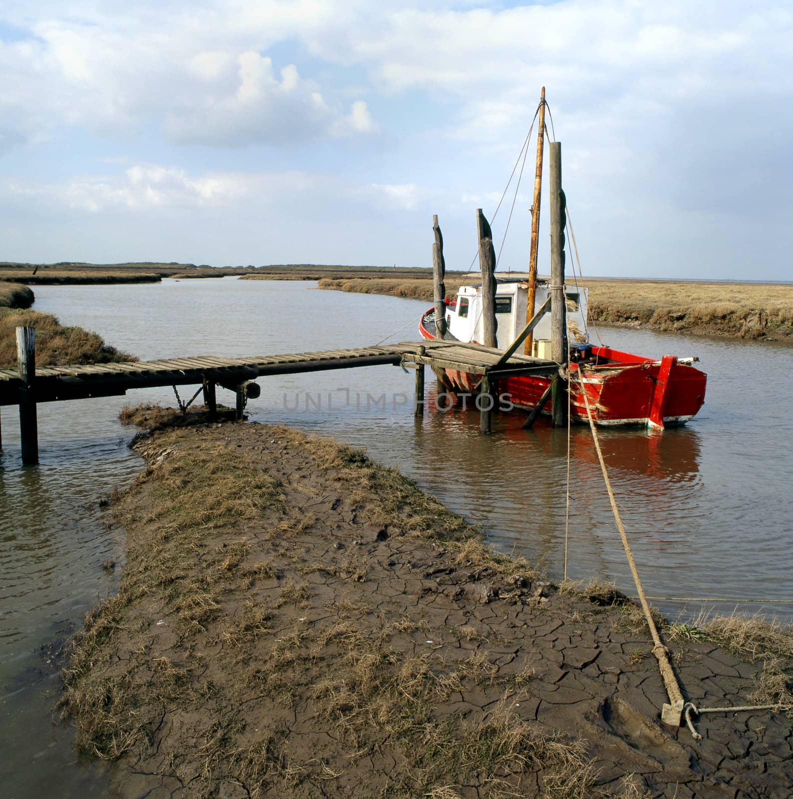 A boat tied up on the fenland of East Anglia