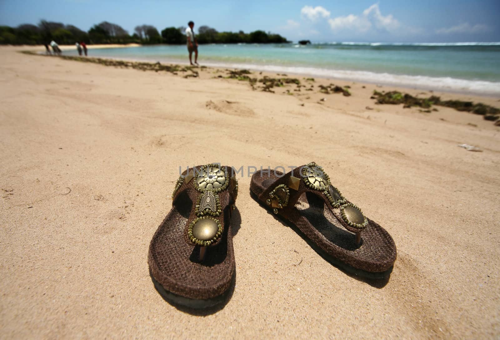 Female slippers on a coast of ocean