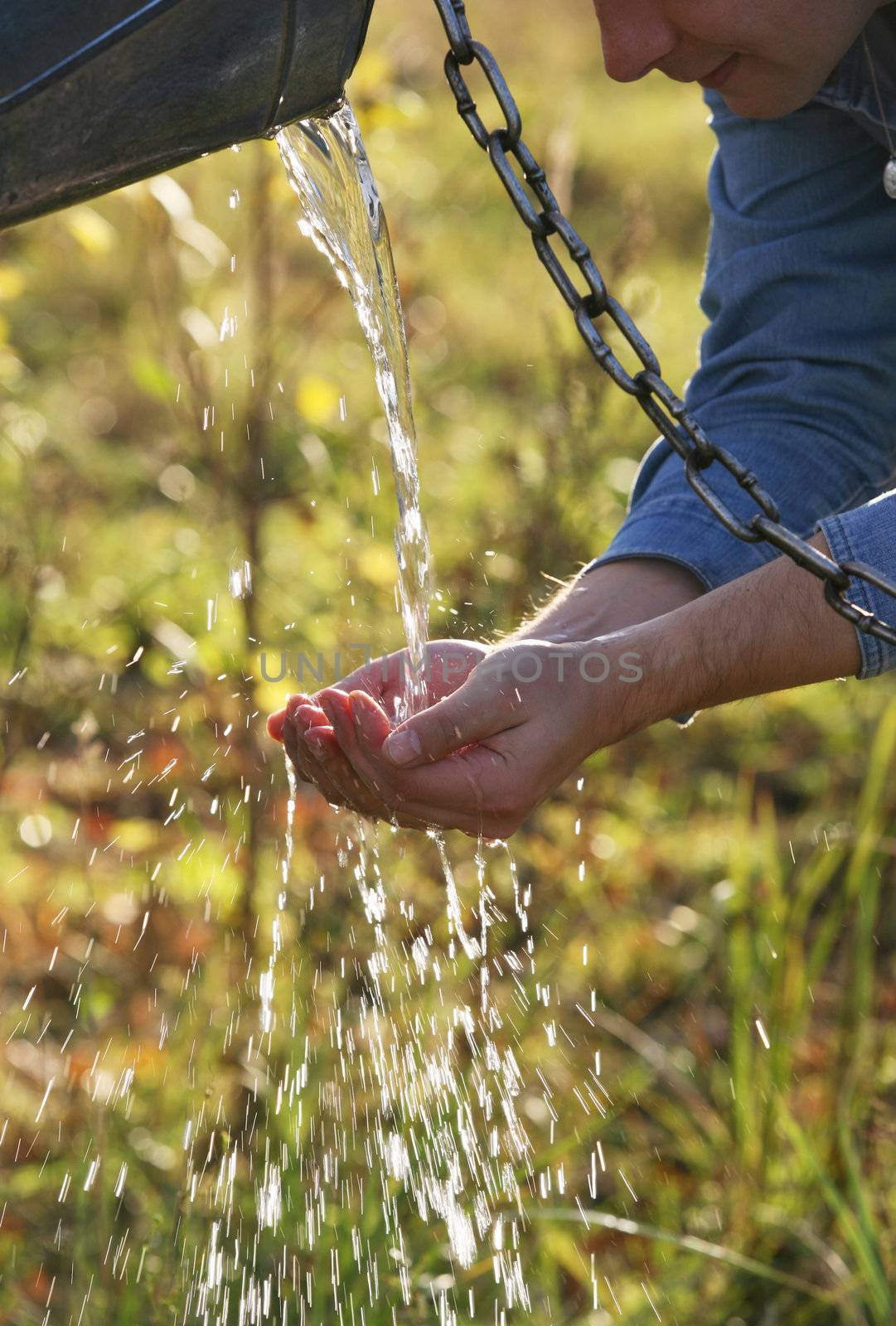 The man washes hands with transparent water