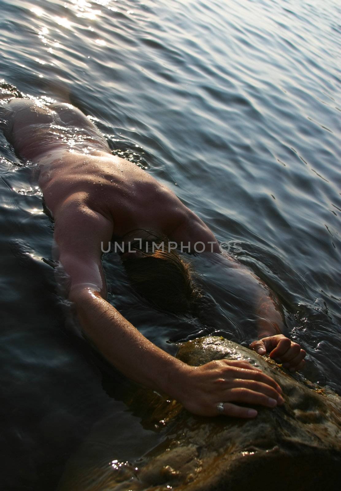 The man with a beautiful body in water