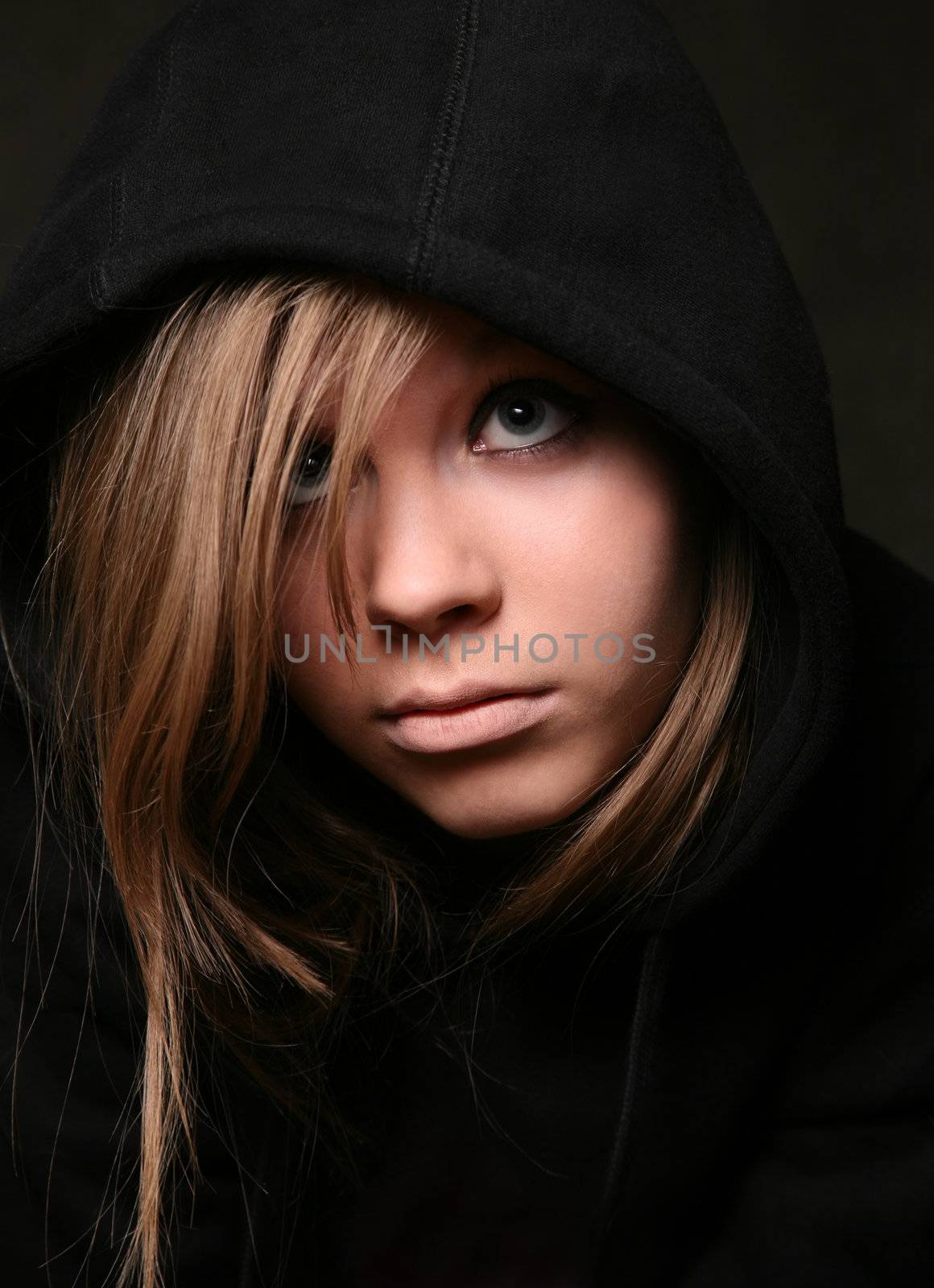 Portrait of the young girl in a black hood