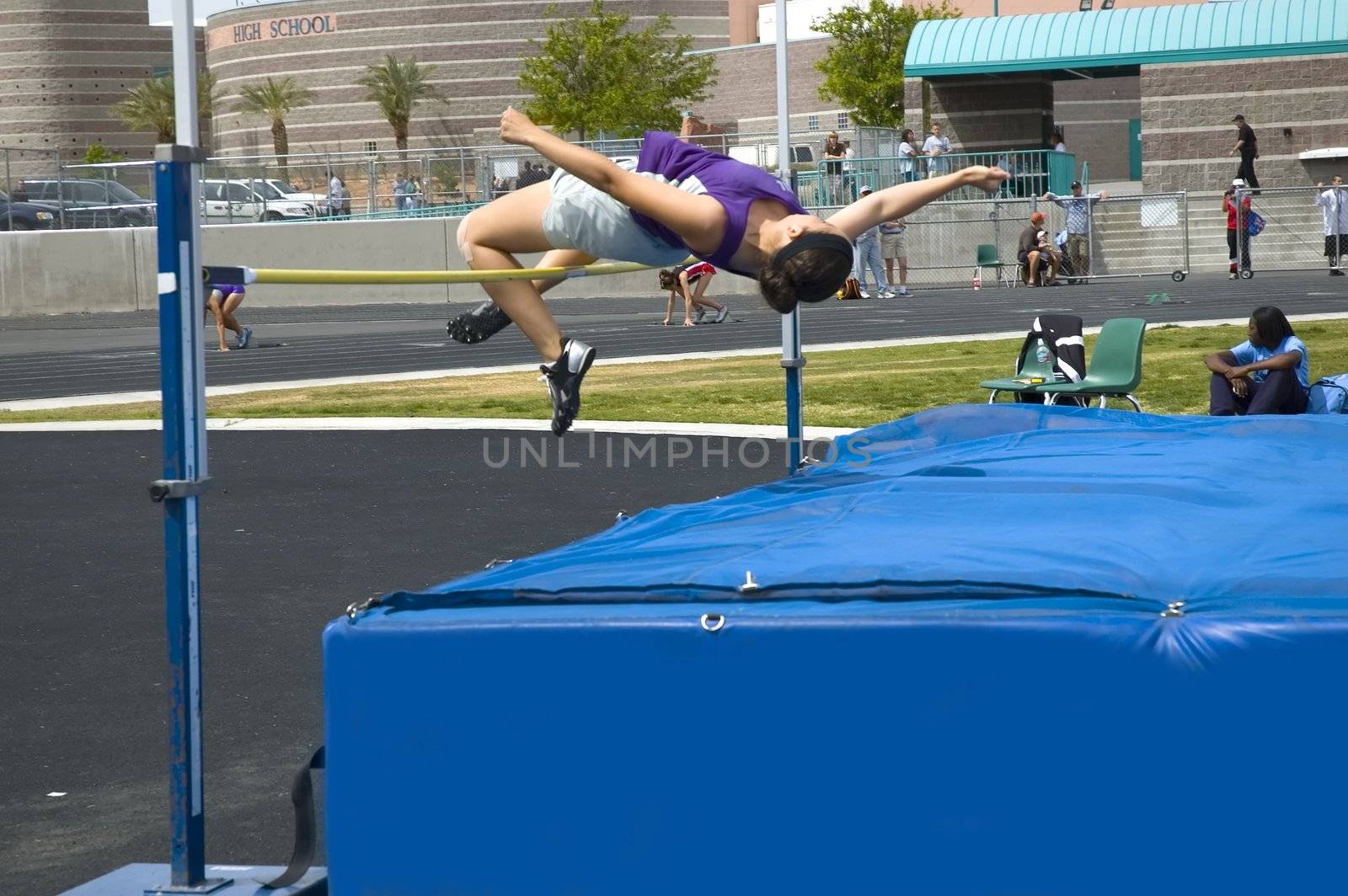 Teenage girl during high jump competition