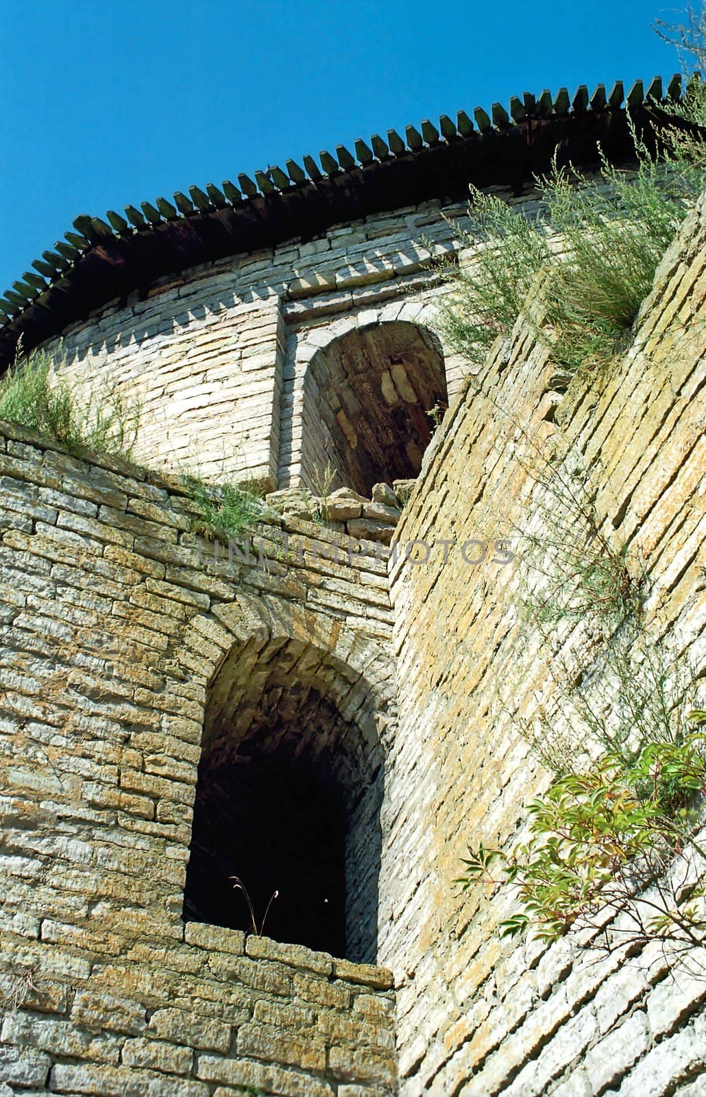 Embrasures of old brick fortress from below
