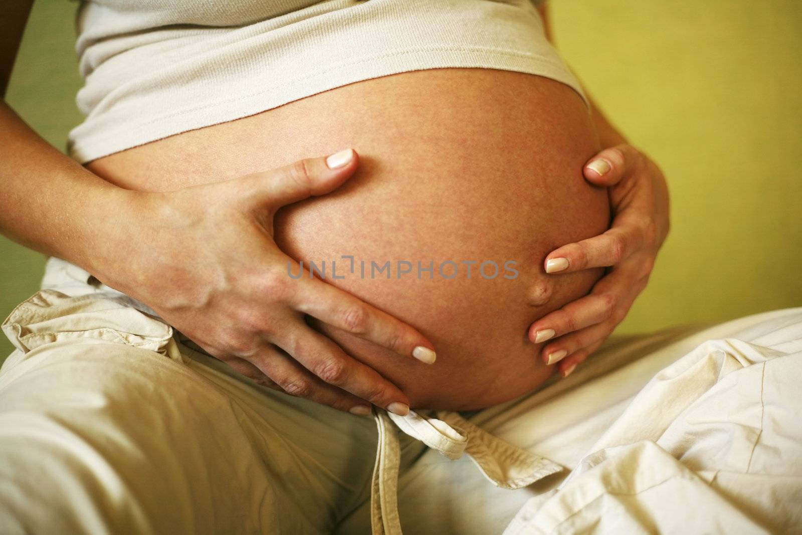 The pregnant woman on the ninth month. The child will be born one of these days