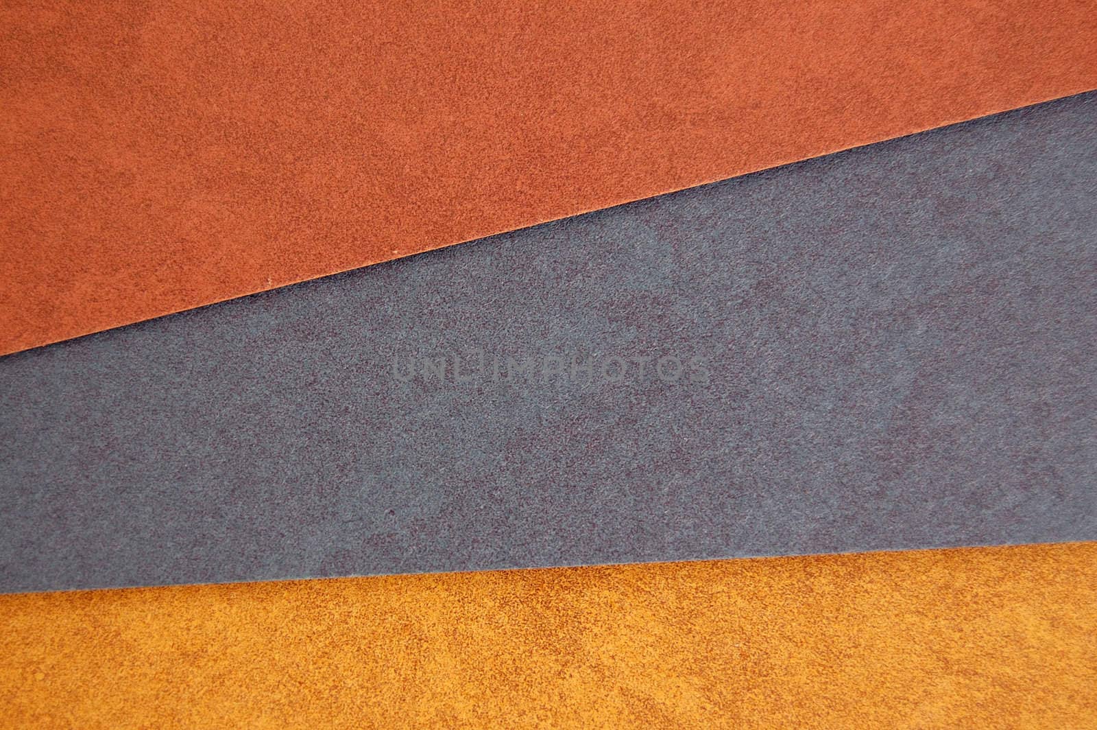 Different colors of recycled paper. Speckled cardboard background texture.