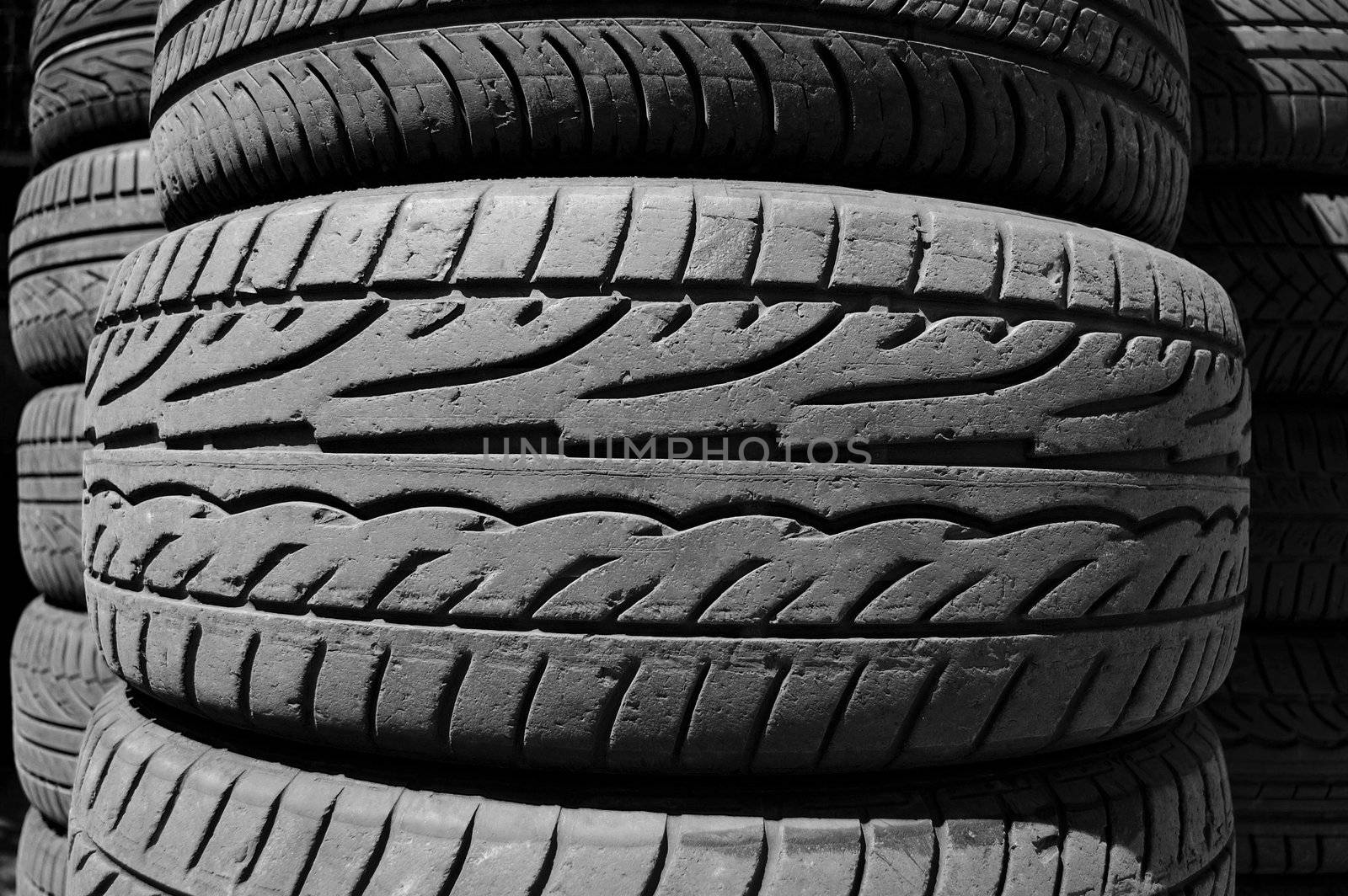 Pile of used car tires background. Black and white.