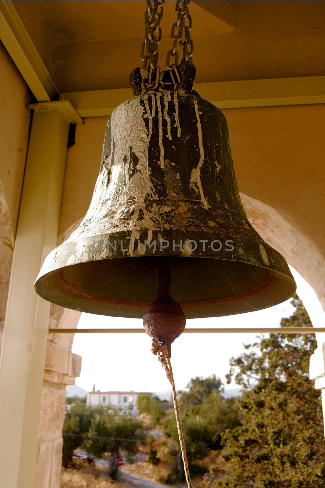 Rusty bell inside an old church tower in a village in Greece.