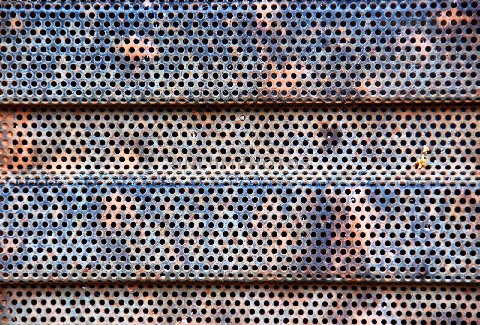 Rusty industrial radiator grill detail. Metal pattern background.