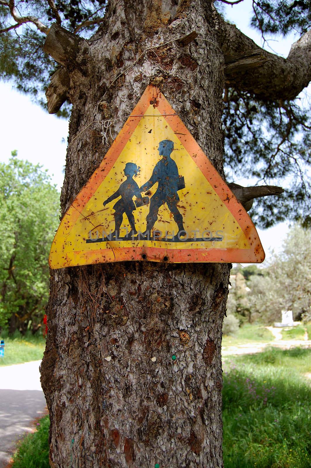 Rusty traffic control warning sign for school children. Speed restriction.