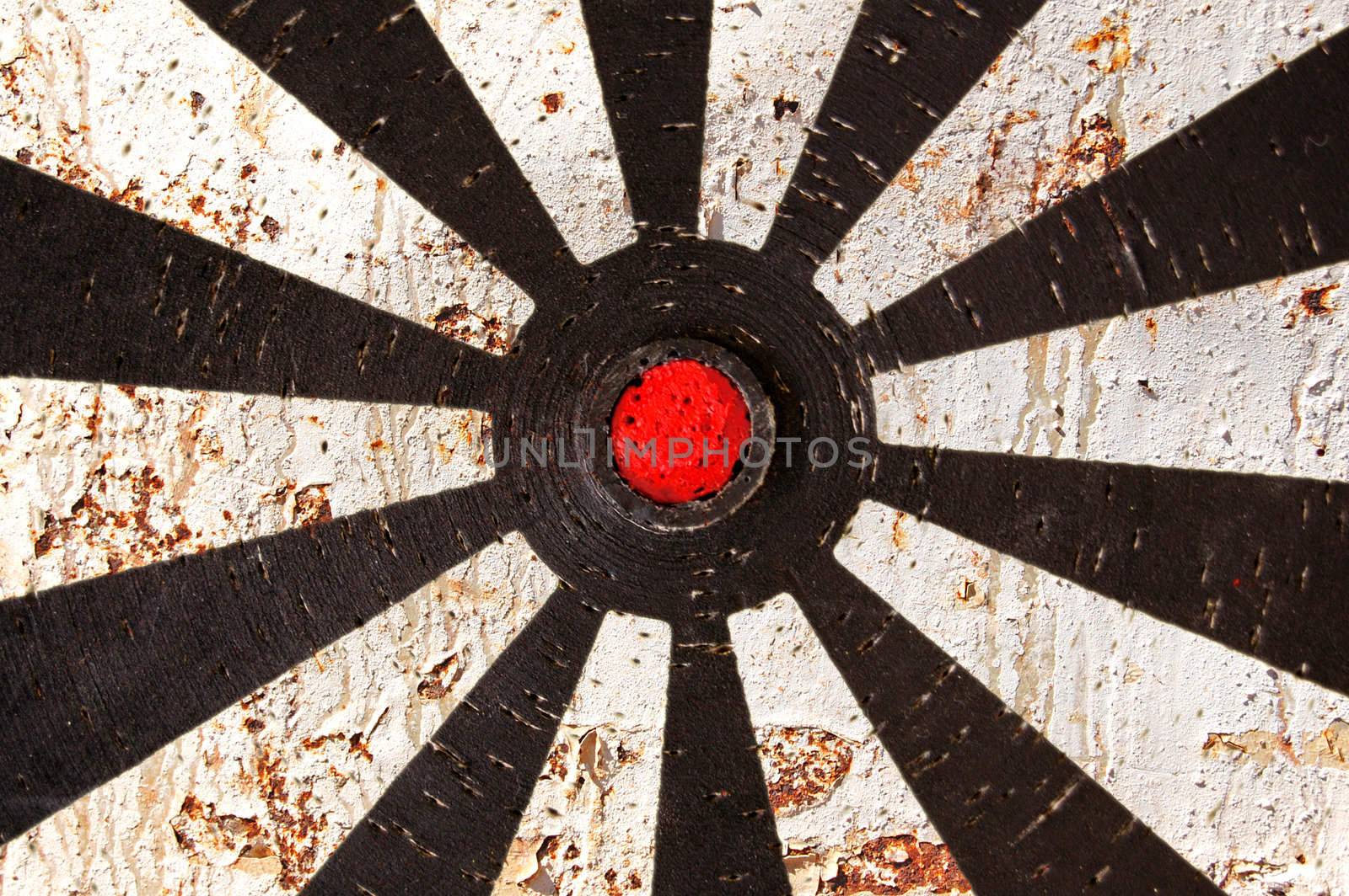 Abstract background. Old dartboard target and rusty metal texture.