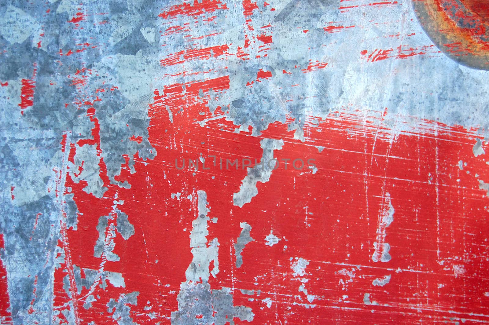 Rusty metal with red scratched paint. Abstract background texture.