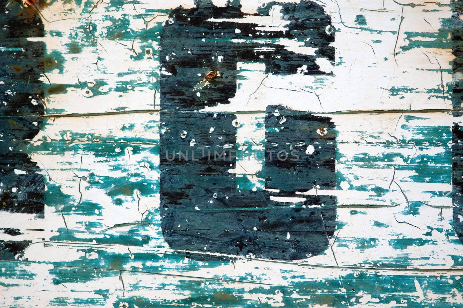 Type stencil detail on weathered and rusty metal surface. Background texture.