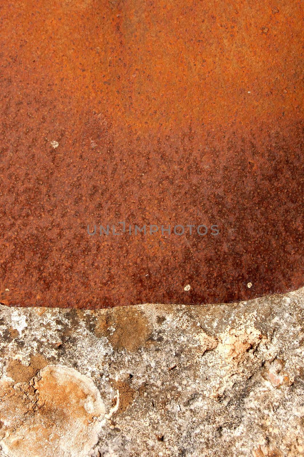 Rusty sheet of metal covering the opening of an old stone well.