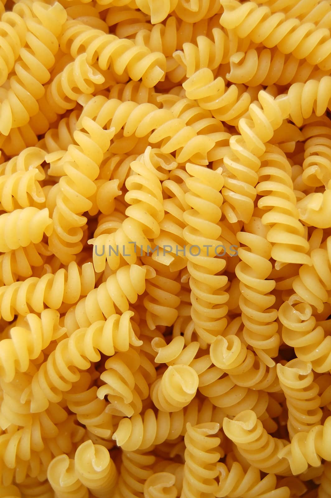 Eliche twirls pasta. Italian food background detail.