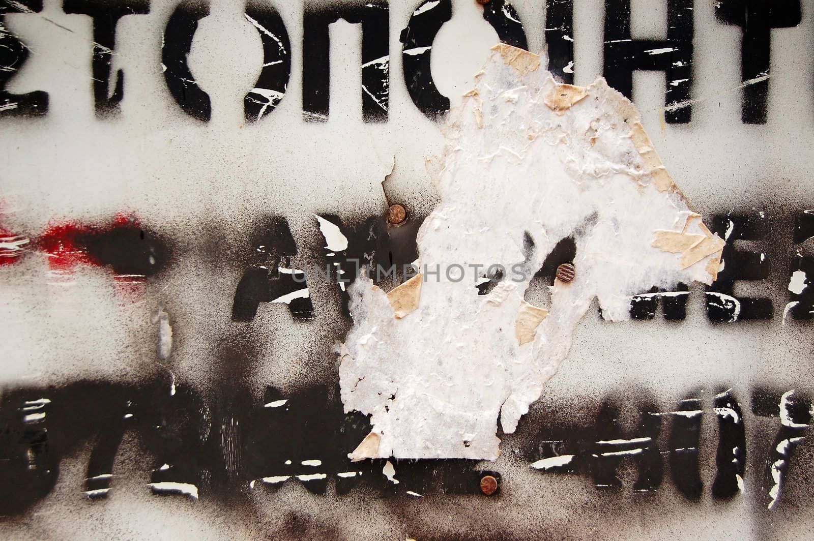 Type stencil on weathered surface. Abstract background texture.
